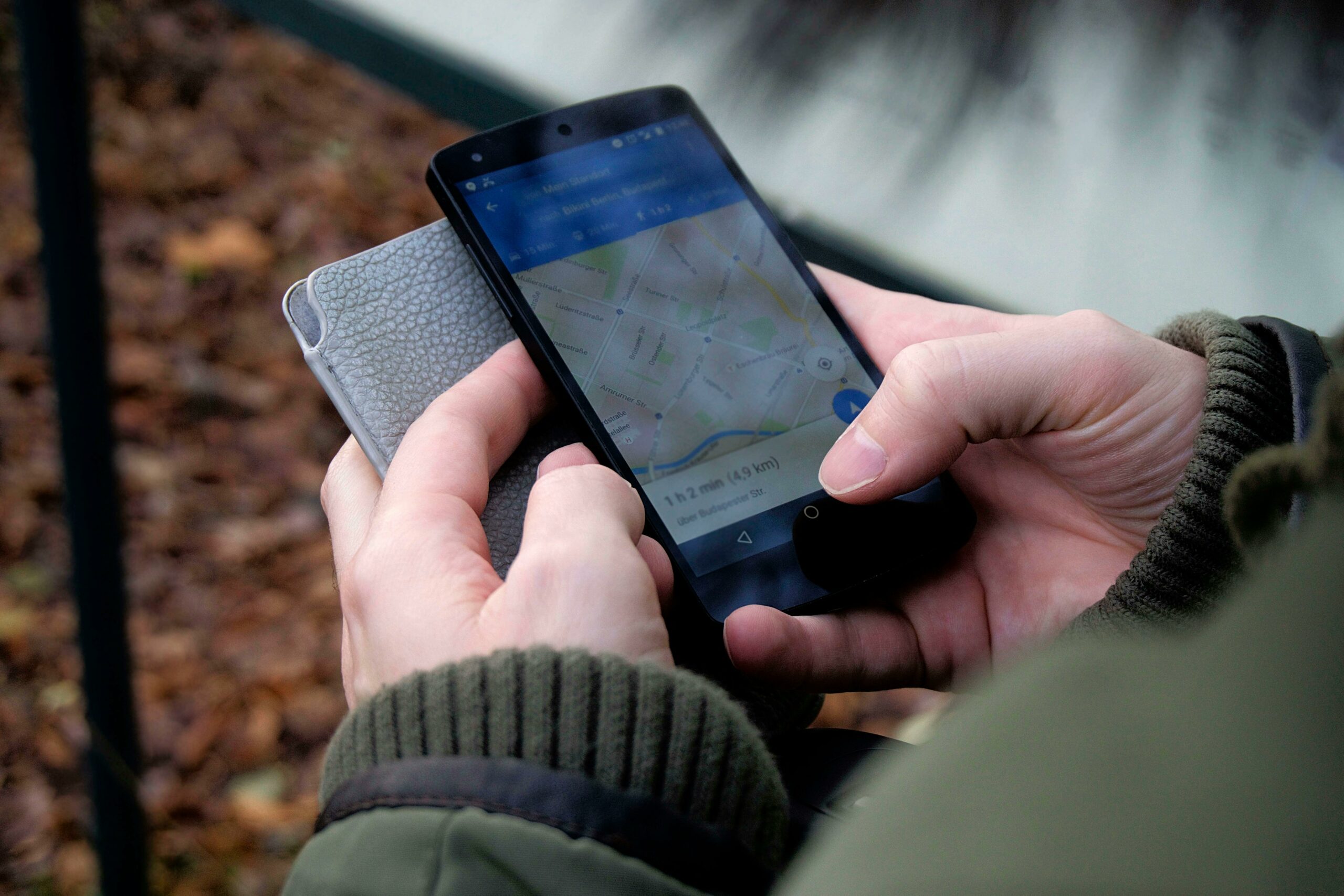 close up of hands holding an iphone, navigating Google Maps